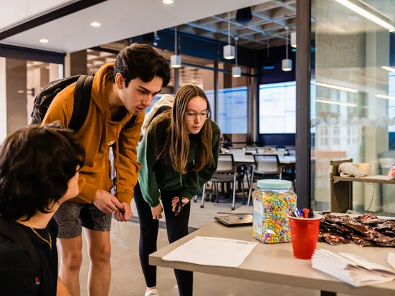 Three students try to estimate the number of M&Ms.